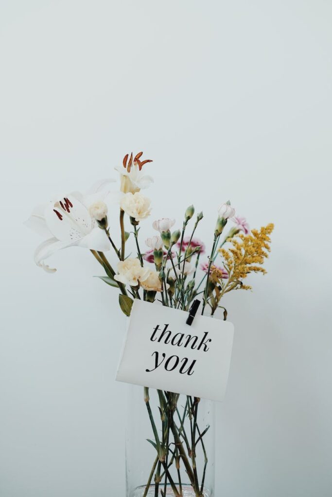 bunch of flowers with a postcard